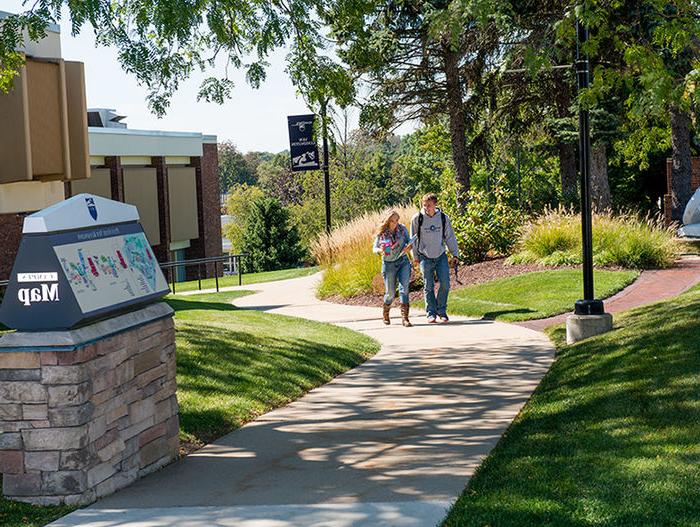 Two students walking on the campus grounds