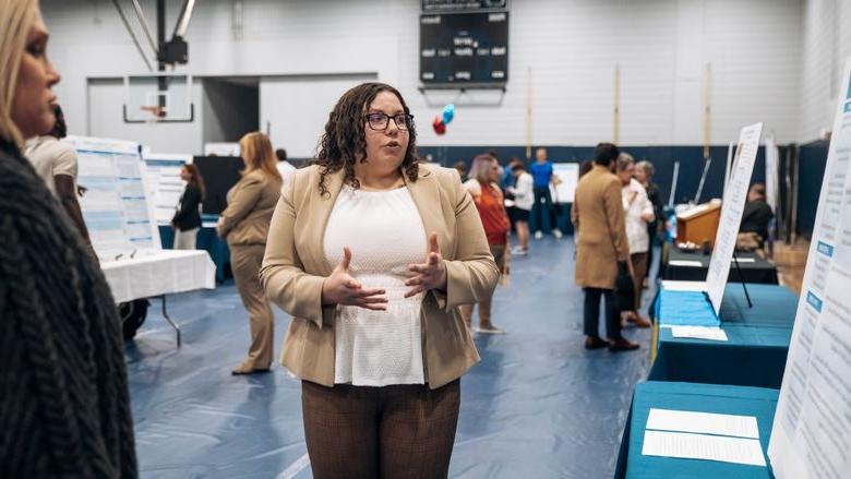 Student stands at research fair